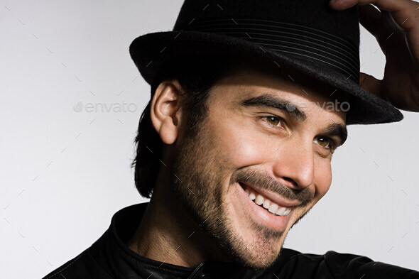 Profile of a young man wearing a fedora - Stock Photo - Images
