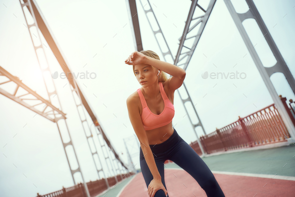 Feeling tired. Portrait of young exhausted blonde woman in sports