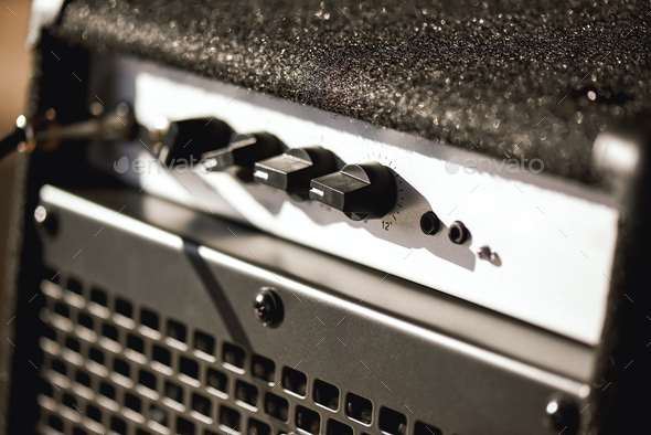 Close-up photo of guitar amplifier with cable audio jack