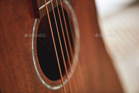 Get to know your instrument. Close up photo of acoustic guitar sound hole