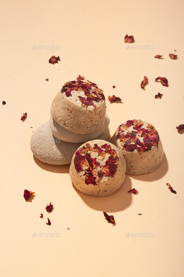 Solid natural shampoo bars, zero waste concept on beige background with petal flowers