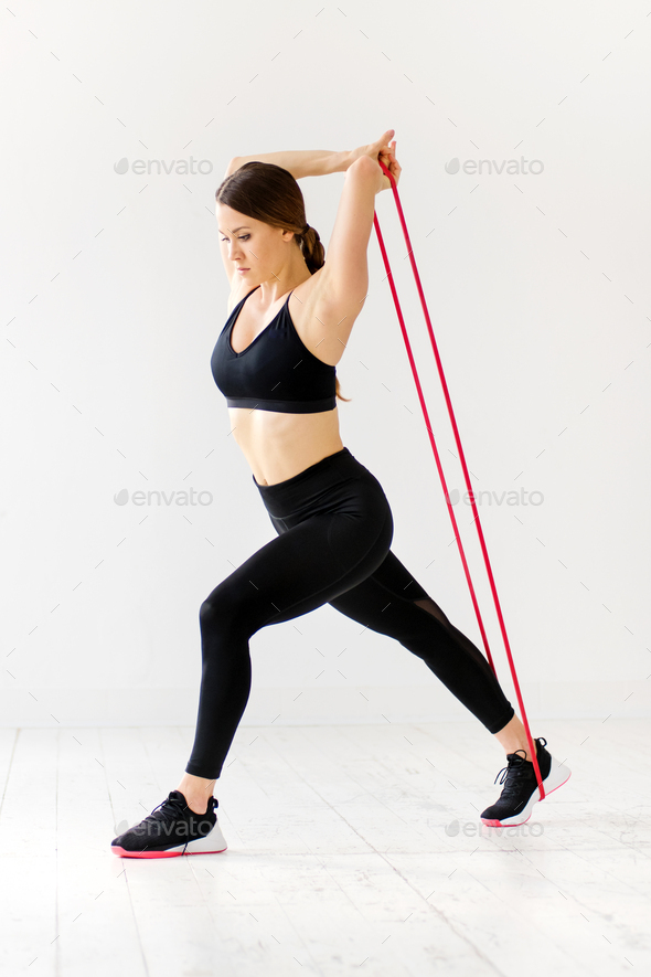Woman doing power band fitness exercises to strengthen muscles
