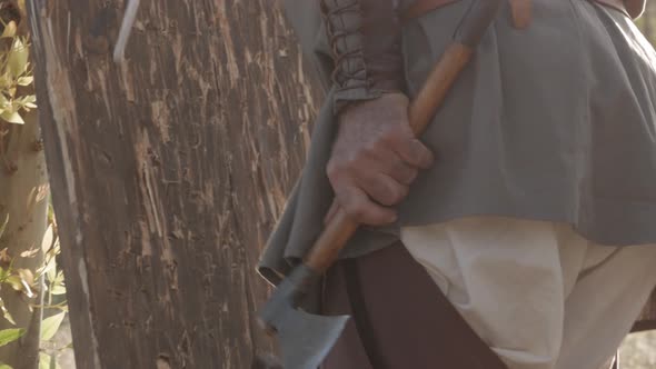 men collect hatchets after an ax shooting competition alt