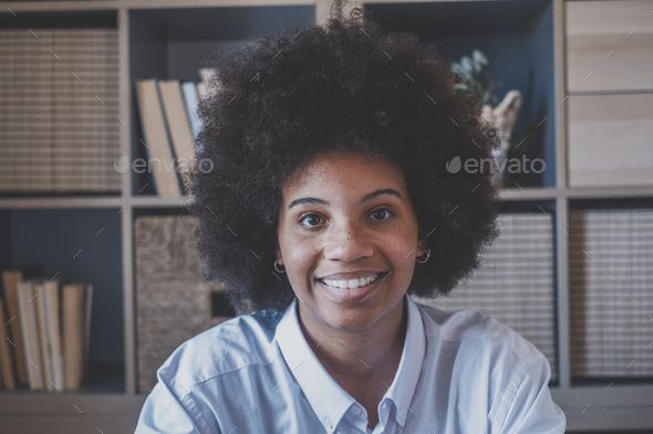 Close Up Portrait Of Attractive Dark Skinned Young Woman With Curly