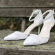 White wedding shoes with lace and heel on old wooden boards - PhotoDune Item for Sale
