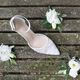 White wedding shoe with white flowers on old wooden boards - PhotoDune Item for Sale