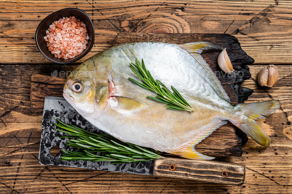 Raw fish Sunfish or pompano on a wooden board. wooden background. Top view  Stock Photo by composter-box