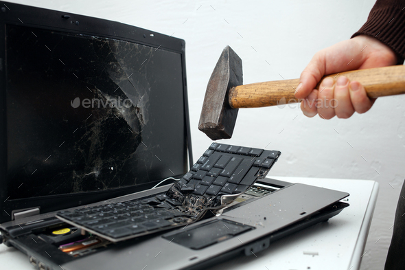 man destroyed laptop with a hammer. Nervous work, buggy computer, errors, slow Internet, not saved