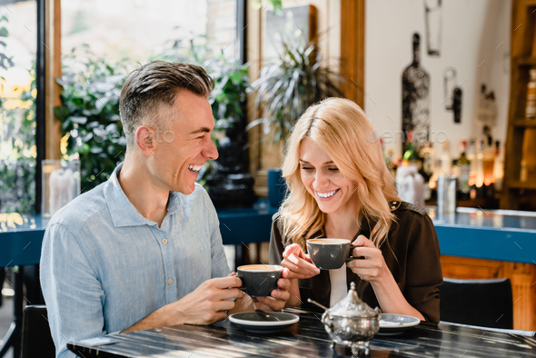 Spouses drinking coffee talking enjoying romantic date together in cafe ...