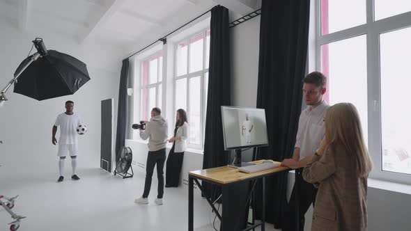 Backstage of Professional Photosession of Afroamerican Footballer in Studio for Magazine alt