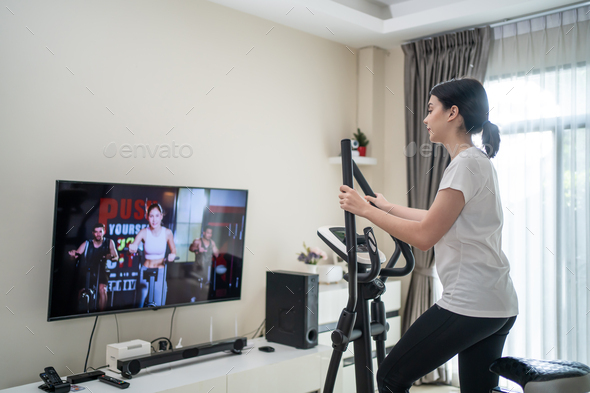 Asian Sport Woman Workout Exercisie By Watching Fitness Live Or Video