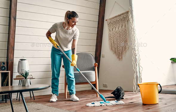 Young Woman Doing Housework And Cleaning. Attractive Girl Mopping