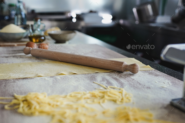 Close up of dough and rolling pin isnde pasta factory