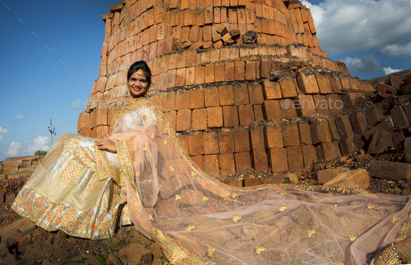 Beautiful Indian bride on bricks background - Stock Photo - Images