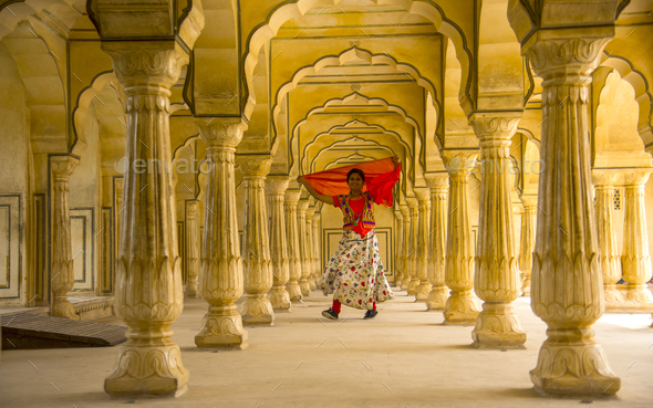 Young female tourist dancing at Pillars room of Amber Fort, Jaipur - Stock Photo - Images