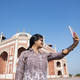 Young girl taking Photos in front of Humayun&#39;s Tomb, Delhi, India. - PhotoDune Item for Sale