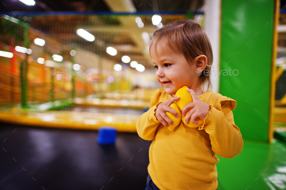 Cute baby girl playing in indoor play center