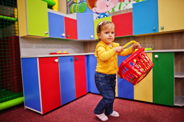 Cute baby girl playing in indoor play center