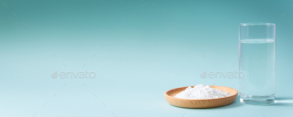Collagen powder and glass of pure water on blue background. - Stock Photo - Images