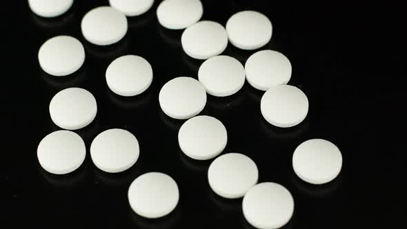 White medical pills rotating closeup. Pills and drugs. Pharmaceutical Industry.