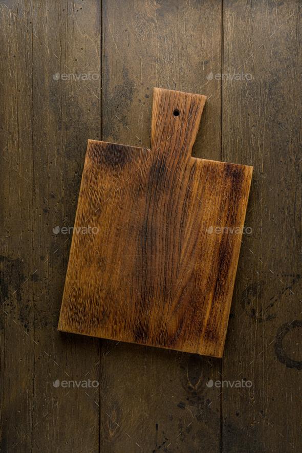 Old wooden chopping board. Food background. Overhead. Vertical