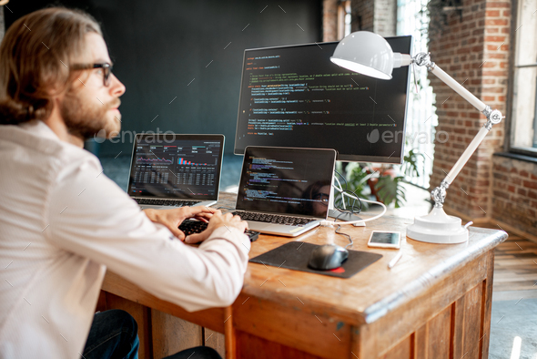 Programmer working with program code Stock Photo by RossHelen | PhotoDune