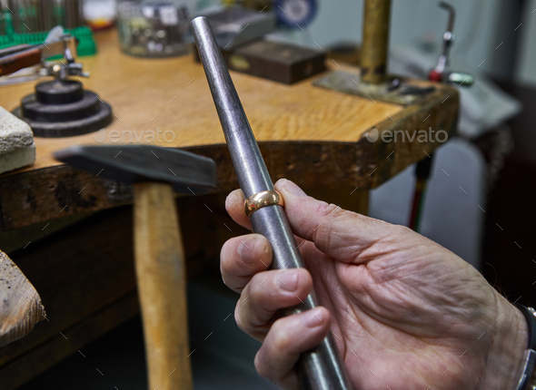 Jewelry production. The jeweler makes a gold ring. The process of measuring the ring
