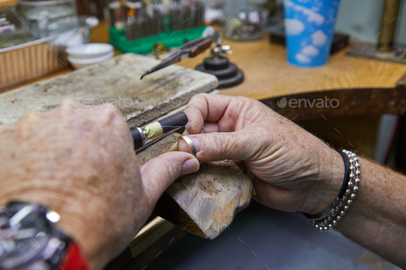 Jewelry production. Jeweler polishes a gold ring