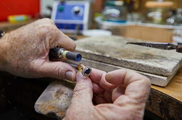Jewelry production. Jeweler polishes a gold ring