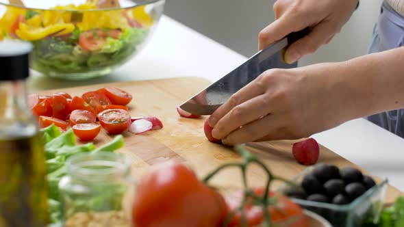 Young Woman Chopping Radish at Home alt