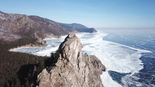 Aerial Perspective View of Beautiful Deep Blue Ice Textured Frozen Baikal Lake Surface and Coast