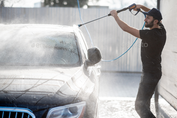 Man Washing Car with Water Gun Stock Image - Image of