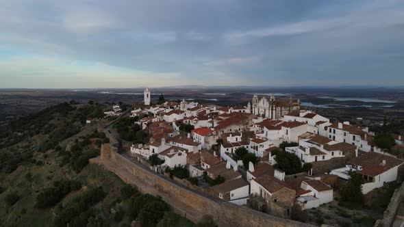 Drone flying over Monsaraz village at sunset, Portugal. Aerial panoramic view alt