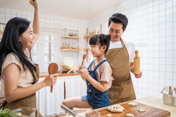 Asian family is cooking in the kitchen together