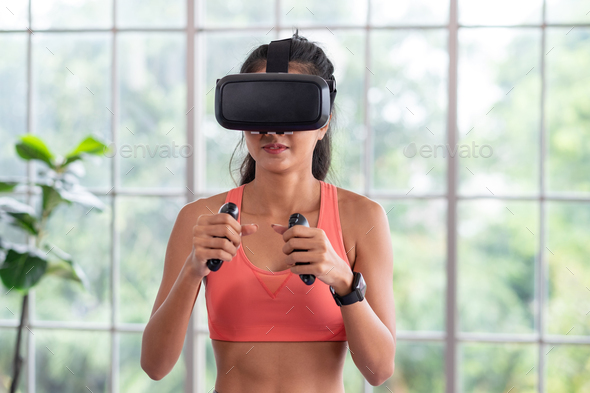 Asian woman wear virtual reality glasses and train boxing - Stock Photo - Images