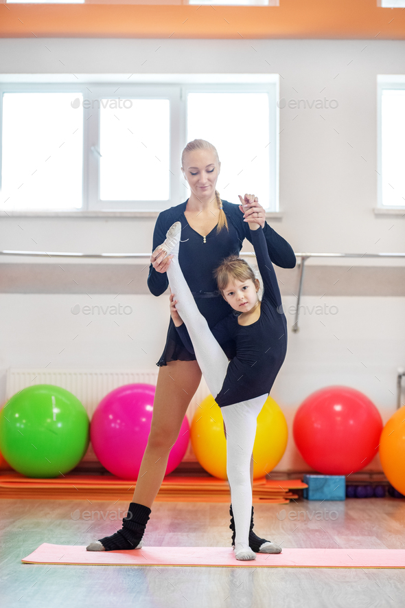The dance coach does the workout with the child. The concept of sports, education, hobbies