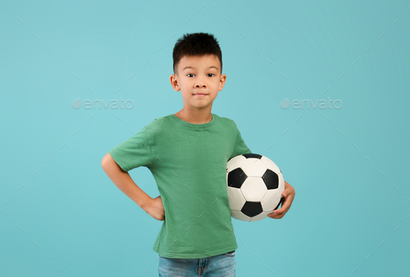 Portrait of cute little boy in sportswear with a soccer ball