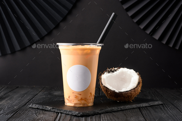 Taiwan milk tea with coconut and mango on wooden background