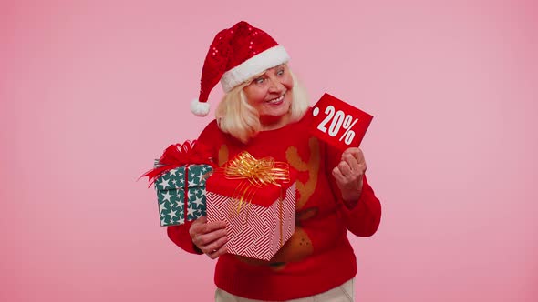 Grandmother in Christmas Sweater Showing Gift Box and 20 Percent Discount Inscriptions Banner Text alt