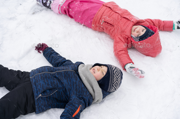 Little children playing with snow. Stock Photo by StiahailoAnastasiia