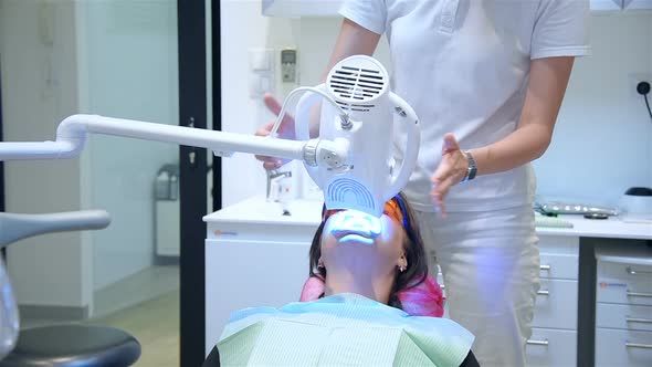 Dentist Performs Procedure Laser Bleaching Teeth In Clinic