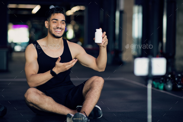 Sport Blog. Young Middle Eastern Man Advertising Fitness Multivitamins In Social Media