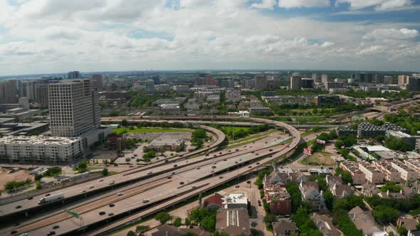 Forwards Fly and Tilt Down Footage of Large Busy Multilane Highway Interchange in Town alt
