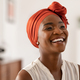 Cheerful african woman wearing trendy red headscarf - PhotoDune Item for Sale