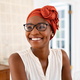 Happy smiling black woman with spectacles wearing african turban - PhotoDune Item for Sale