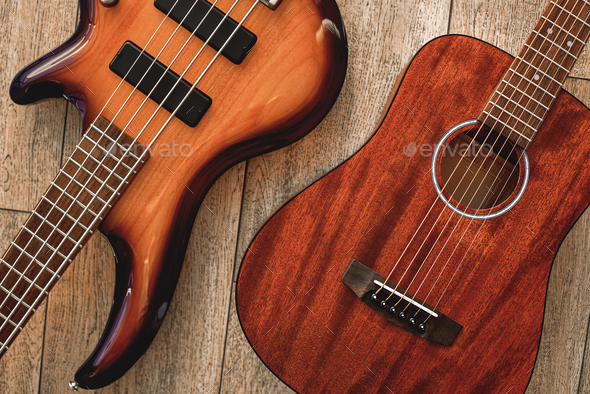 What to choose Top view on two cool musical instruments: acoustic and electric guitars are lying on