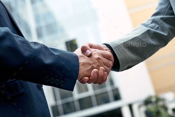Business people shaking hands, Greeting Deal Concept, modern city background - Stock Photo - Images
