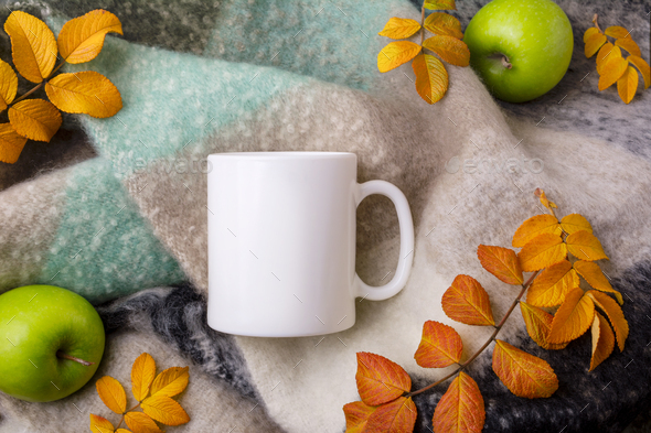 White coffee mug mockup with woolen blanket, apples and fall leaves - Stock Photo - Images