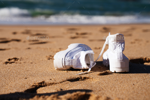 White sneakers on the beach - Stock Photo - Images