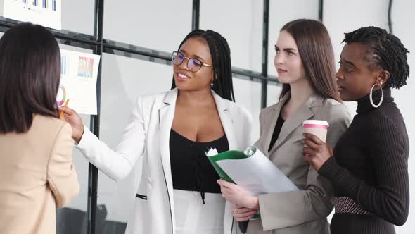 Woman Present Project to Colleguess at Office alt